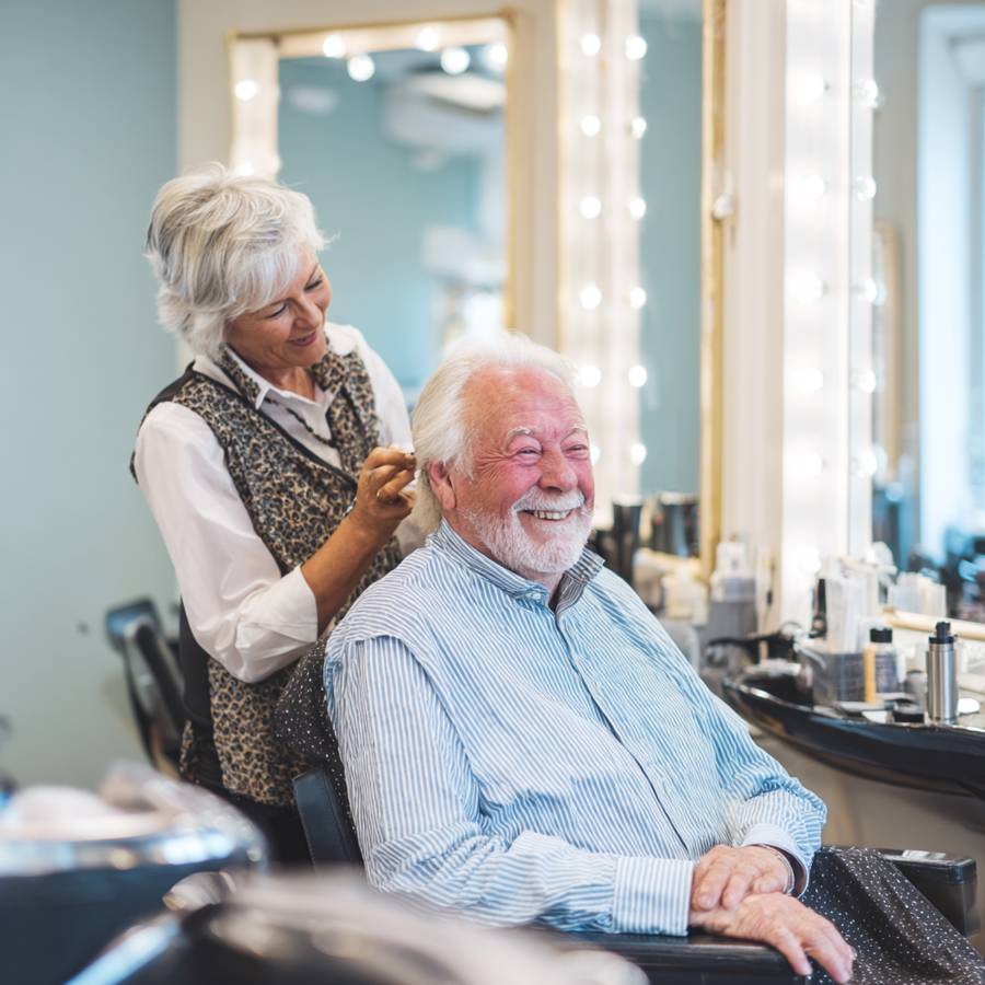 Care facility resident smiling after hair trim